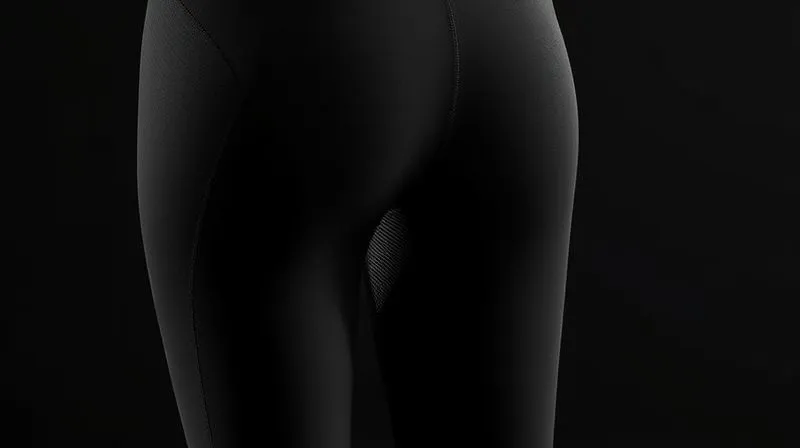 A photorealistic 3D render of a pair of high-performance black activewear leggings, with clearly visible, subtly integrated mesh panels behind the knees and along the outer thighs. The primary fabric appears dense and opaque, while the mesh shows light filtering through. Professional photography, 8K, cinematic lighting, sharp focus on the fabric details, depth of field, shot on a high-end DSLR, highlighting functional design.