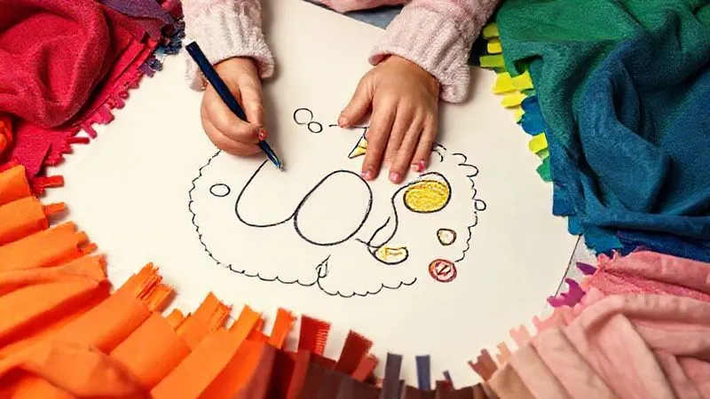 A child's hand drawing a unique, whimsical design on a large piece of paper, surrounded by colorful, distinct fabric swatches, symbolizing the creation of a unique design philosophy. photorealistic, professional photography, 8K, cinematic lighting, sharp focus, depth of field, shot on a high-end DSLR.