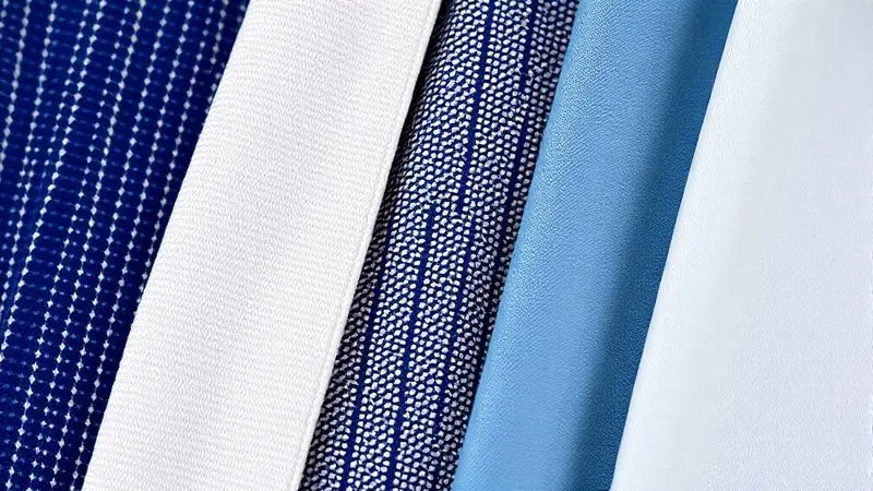 A macro, photorealistic shot of various fabric swatches for school uniforms: one showing a tight twill weave, another a ripstop pattern, and a third a smooth polyester blend. Each swatch is labeled with a small, elegant tag. professional photography, 8K, cinematic lighting, sharp focus, depth of field, shot on a high-end DSLR.