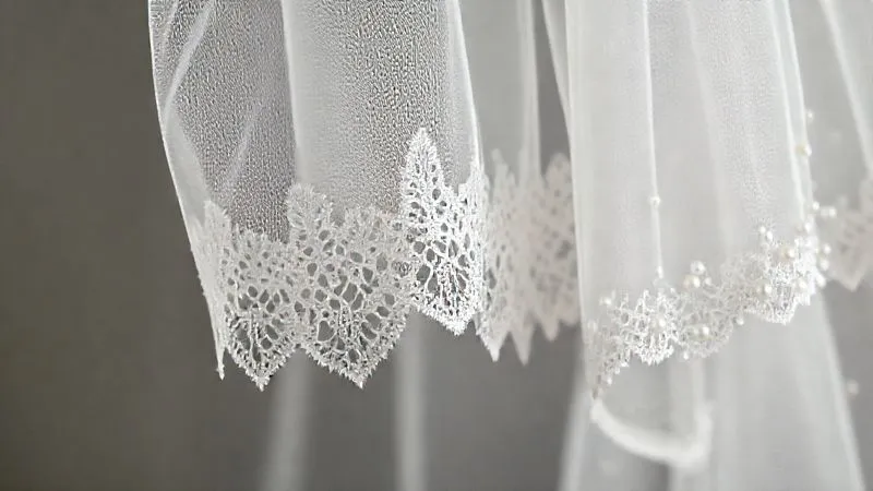 A photorealistic, professional photography close-up of three distinct wedding veil edges: one with a clean, raw cut, one with delicate Chantilly lace trim, and one with scattered pearl embellishments. The veils are draped elegantly, showcasing the texture and detail of each edge, under soft, cinematic lighting with a sharp focus on the intricacies. 8K hyper-detailed, shot on a high-end DSLR.